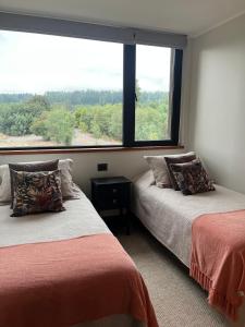 Postel nebo postele na pokoji v ubytování Departamento La Puntilla de Villarrica Orilla Lago + 16 fotografií