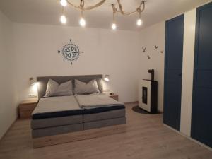 a bedroom with a bed with a nautical sign on the wall at Appartement blue Dinghi in Mörbisch am See
