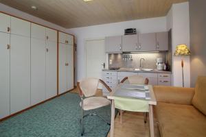 a living room with a couch and a table and chairs at Haus Waterkant in Breege