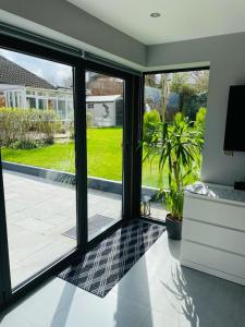 a living room with sliding glass doors to a patio at Natures Corner in Aldenham