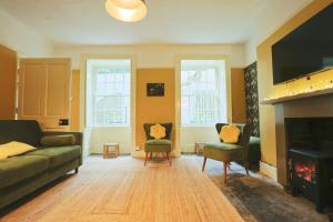 a living room with a couch and a fireplace at Two Bedroom flat in Caledonia Place in Bristol