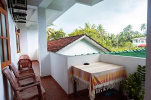 a balcony with a table and chairs in a house at SHYNI Guest House in Hikkaduwa +34 photos