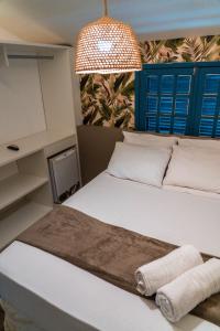 a bedroom with a bed with two towels on it at Apprezzare . Pousada beira-mar in Porto De Galinhas +54 photos