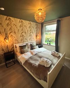 a bedroom with a large bed with a wall at B&B Borgersteeg in Neede