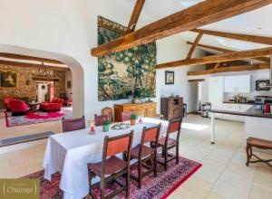 a kitchen and living room with a table and chairs at L'éco-Domaine du Chalonge in Héric