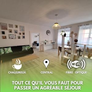 a living room with a couch and a table at Urban Green Spirit - Centre historique, familial in Mulhouse