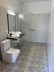 a bathroom with two sinks and a toilet and a mirror at Cicáskacus Vendégház in Matrafured