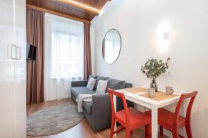 a living room with a table and a couch at Cozy studio in the city center in Vilnius