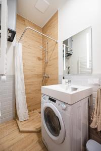 a bathroom with a washing machine and a sink at Cozy studio in the city center in Vilnius +43 photos