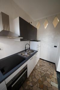a kitchen with a sink and a counter top at Venezia House in Mestre +15 photos