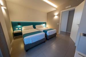 Postel nebo postele na pokoji v ubytování Airone City Hotel