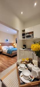 a room with a bed and a table with dishes at Apartments Miljas 1 in Dubrovnik