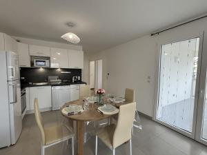 a kitchen and dining room with a table and chairs at View Point Imperial lake in Annecy