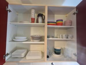 a cabinet filled with plates and bowls and dishes at Holiday Apartment near Triberg Waterfall in Triberg