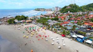 an aerial view of a beach with people with umbrellas at Pousada Praia do Sonho in Itanhaém