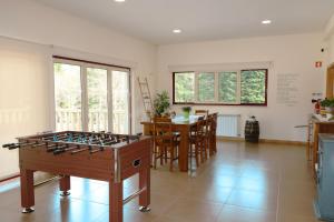 a living room with a foosball table in the middle at Outeiro do Moinho in Campo do Gerês