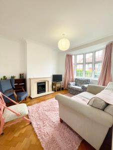 a living room with a couch and a fireplace at Greater London House with excellent transport in Forest Hill