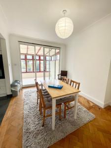 a dining room with a table and chairs at Greater London House with excellent transport in Forest Hill