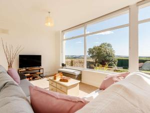 a living room with a couch and a large window at 4 Bed in Montrose 89698 in Brechin