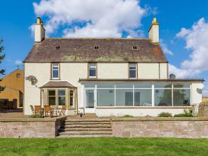 a large white house with large windows at 4 Bed in Montrose 89698 in Brechin