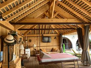 Saint-AndiolにあるMas de la Mareの木製の天井の客室で、ベッド1台、テレビが備わります。