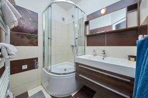 a bathroom with a shower and a toilet and a sink at Chilli apartment in Bratislava