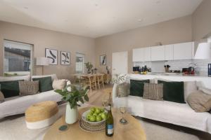 a living room with two white couches and a table at Salt Life, Dunes at Upton Towans in Hayle