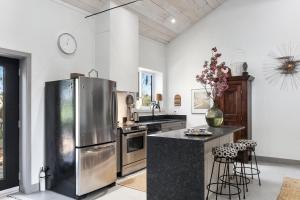 a kitchen with a stainless steel refrigerator and a counter at The Barns of Brighton Near Prince Edward County in Brighton