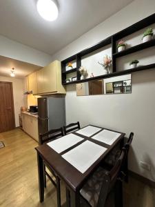 a kitchen with a table and chairs and a refrigerator at Matty’s homestay in Manila