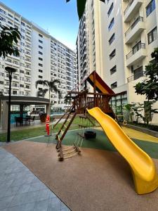 a playground with a slide in a city at Matty’s homestay in Manila