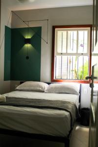 a bed in a room with a window at Reserva 69 Hostel in Sao Paulo