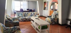 a living room with two couches and a table at Seacastle Guesthouse in Port St Johns