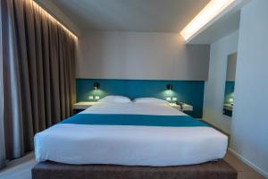 Postel nebo postele na pokoji v ubytování Airone City Hotel