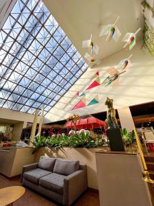 a lobby with kites flying in the ceiling at Castro's Park Hotel in Goiânia
