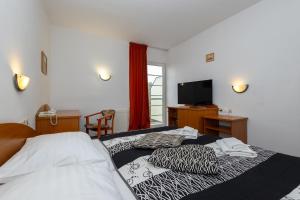 Posteľ alebo postele v izbe v ubytovaní Hotel pod Zámkom