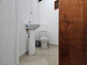 a bathroom with a sink and a toilet at Casa Grande Surf in Guachaca