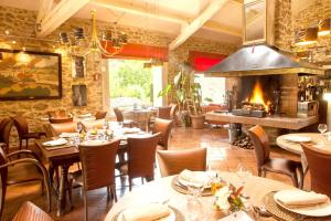 a restaurant with tables and chairs and a fireplace at Studio avec piscine partagee jardin clos et wifi a Forcalquier in Forcalquier