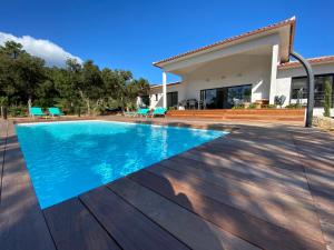 a swimming pool in front of a house at VILLA ISULA by Intendance Excellency in Sainte-Lucie de Porto-Vecchio