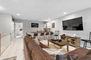 a living room with a couch and a table at Heart of Southie - Hot Tub + Walk to Top Bars in Boston