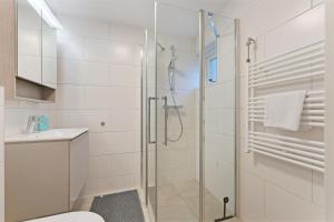 a bathroom with a shower and a toilet and a sink at Jonkerstee 217 - Ouddorp - NOT FOR COMPANIES in Ouddorp +34 photos