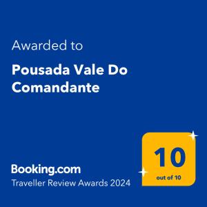 a yellow sign with the text awarded to pussada vale doommant at Pousada Vale Do Comandante in Macacos