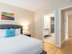 a bedroom with a large bed and a bathroom at Family Friendly Apartment Downtown in Stamford