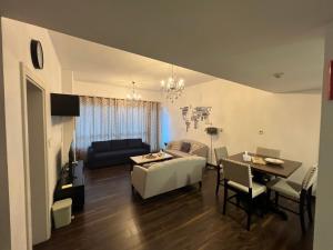 een woonkamer met een bank en een tafel bij Large size one bedroom apartment with sea view in Abu Dhabi