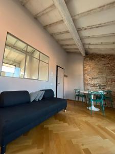 a living room with a blue couch and a table at Casa di Bianca e Emma in Lucca