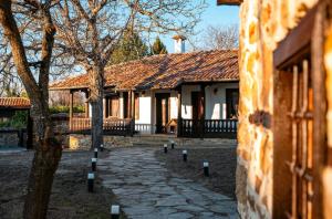 a building with a stone path in front of a building at Holiday Complex ARBANASHKI STYLE-Panoramic View, Jacuzzi, Sauna, Children's park- ALL SPA SERVICES are INCLUDED in the price in Veliko Tŭrnovo