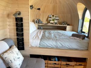 a bedroom in a tiny house with a bed at The Pasty - Lydcott Glamping in East Looe