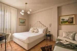 1 dormitorio con cama blanca y sofá en Daplace - Antica Casa Coppo, en Venecia