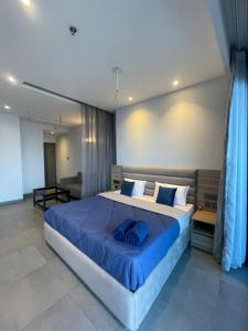 a bedroom with a large bed with blue pillows at The Sky Stay (By Vrs) in New Delhi