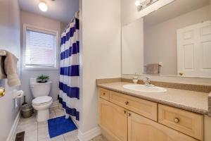 a bathroom with a sink and a toilet at Tasha Dr Suites, 4BR in Mississauga