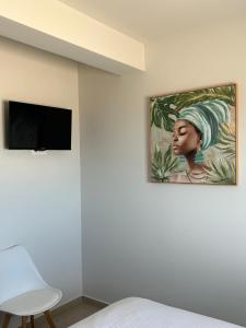 a painting of a woman hanging on a wall at A & G Apartments in Kolymvari